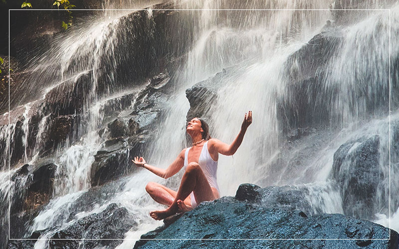 Girl under waterfall