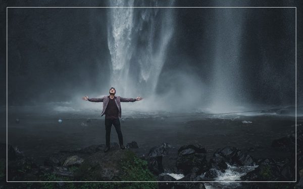 Man under waterfall